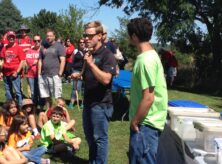 Austen Hill is teaching about reptiles to a group while holding a snake.